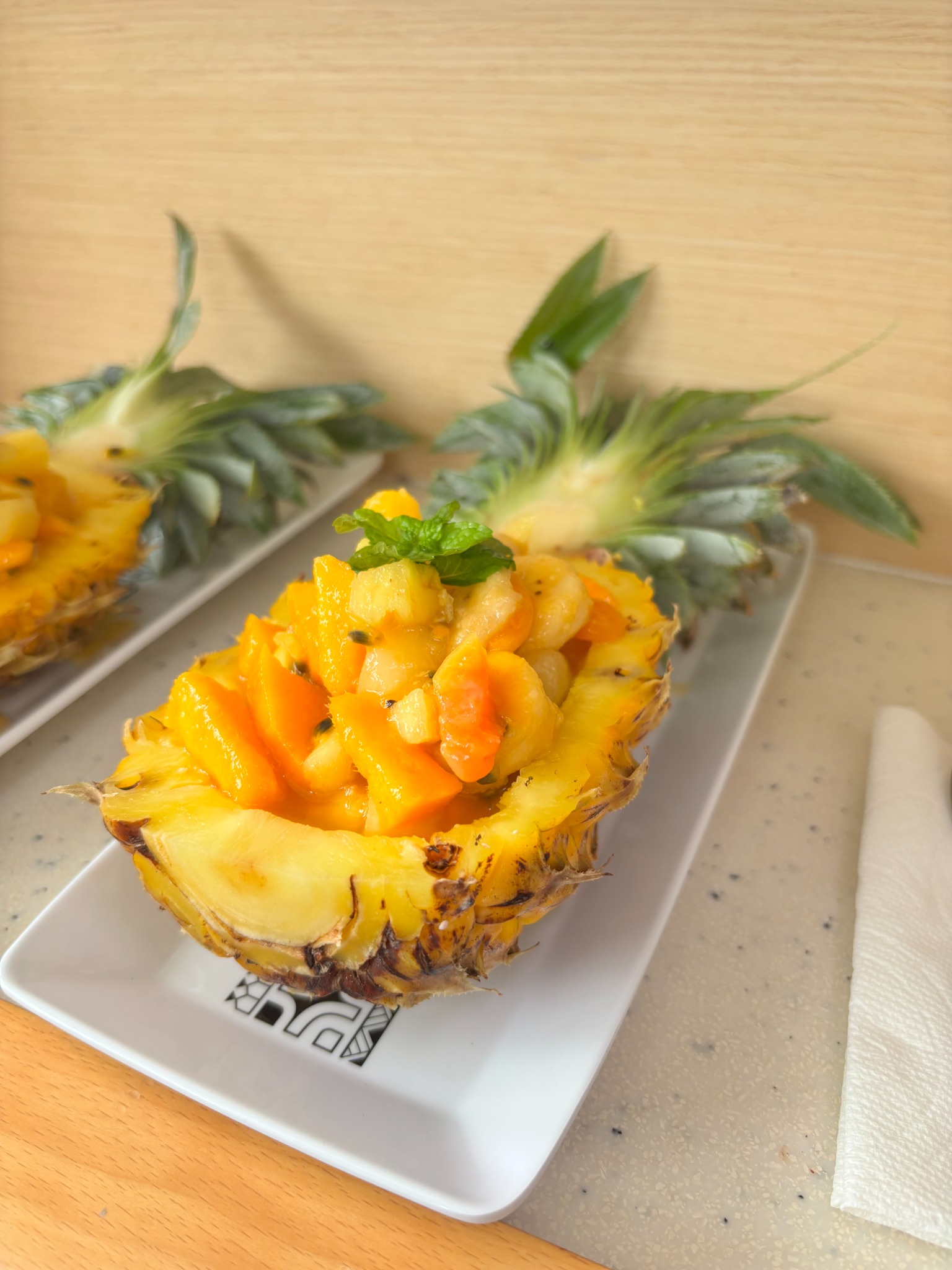 Fresh tropical fruit served in a pineapple half